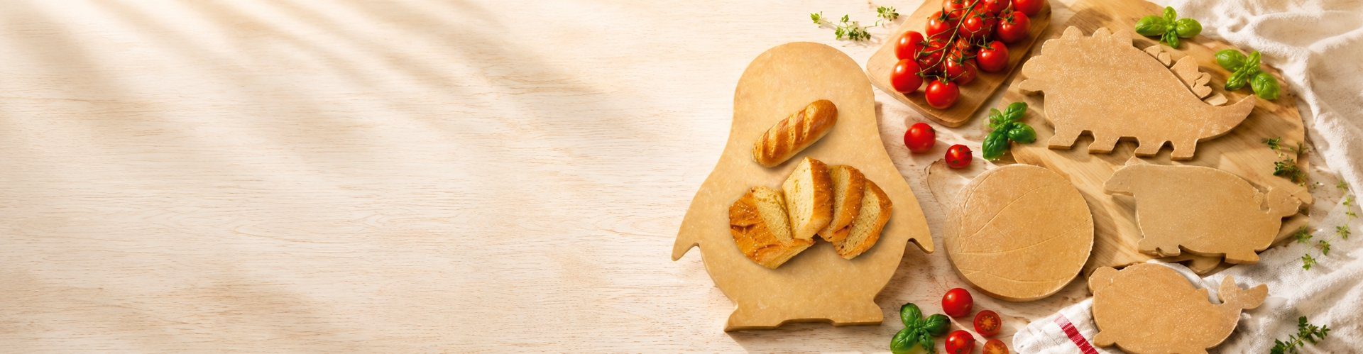 Children Board banner showing animal-shape wood fiber boards with bread, tomatoes and basil